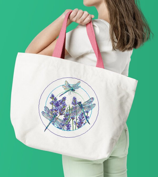 Woman with white tote bag Lavender dragonfly cross stitch pattern - stitched mock up on tote bag
