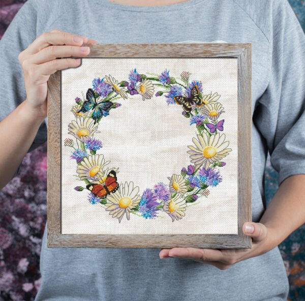 Mock up frame with cornflower wreath and butterfly cross stitch embroidery