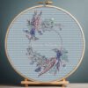 Boho wedding wreath cross stitch pattern with blue florals in embroidery hoop