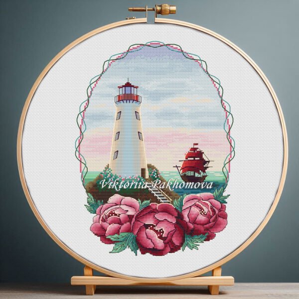 Summer lighthouse cross stitch with floral peonies and coastal scenery in embroidery hoop