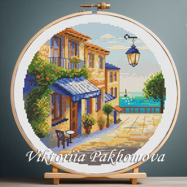 Colorful Cyprus summer landscape cross stitch pattern in an embroidery hoop,