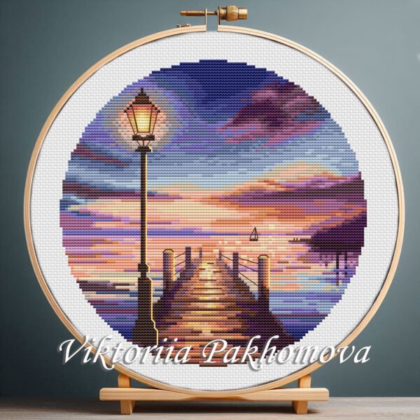 131 Colorful sunrise cross stitch pattern with a wooden pier, glowing sky, calm water, and a vintage lamp, marine coastal landscape design by Viktoriia Pakhomova