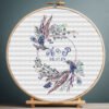 Boho wedding wreath cross stitch pattern with blue florals in embroidery hoop