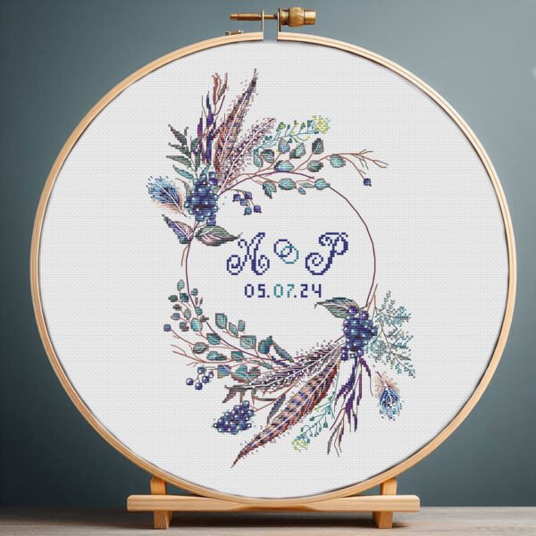Boho wedding wreath cross stitch pattern with blue florals in embroidery hoop