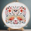 Romantic Swans cross stitch pattern displayed in a wooden embroidery hoop with bright folk‑art motifs