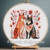 Romantic Dogs cross stitch pattern displayed in a wooden embroidery hoop with warm folk‑art flowers