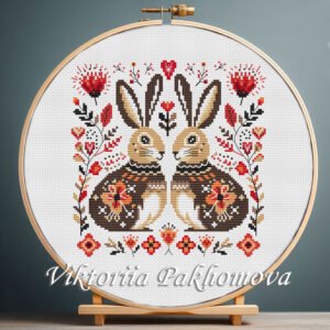 Romantic Bunny cross stitch pattern displayed in a wooden embroidery hoop with warm folk‑art flowers