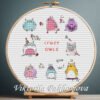 131 Crazy Owl cross stitch pattern bundle displayed in a wooden embroidery hoop with bright pastel colors