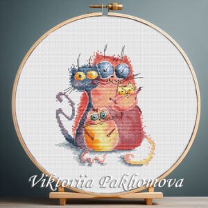 Cross stitch embroidery of four colorful whimsical cats with large expressive eyes, displayed in a wooden hoop.