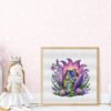 Framed cross stitch artwork of a purple fairy house surrounded by lavender flowers and summer greenery