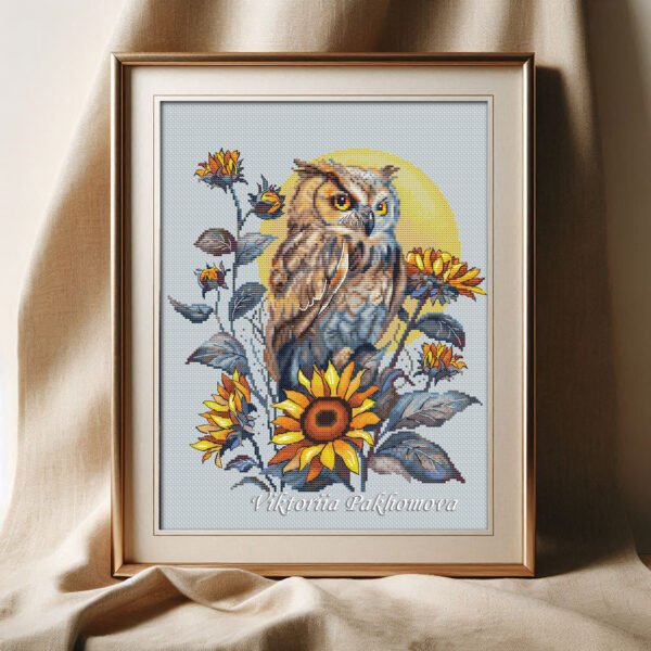 Framed tawny owl and sunflower cross stitch artwork with soft moon background, nature embroidery