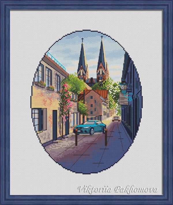 Framed Neuruppin Germany cross stitch pattern with European cityscape and blue car