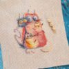 1idSkGAwEfM embroidered cross stitch artwork featuring four bright, playful cats in bold colors with whimsical expressions.