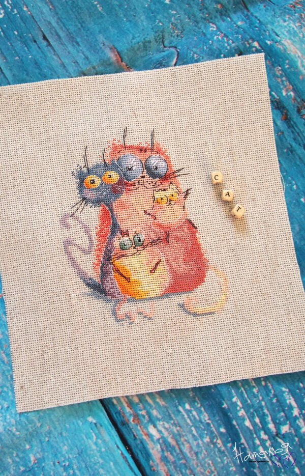1idSkGAwEfM embroidered cross stitch artwork featuring four bright, playful cats in bold colors with whimsical expressions.