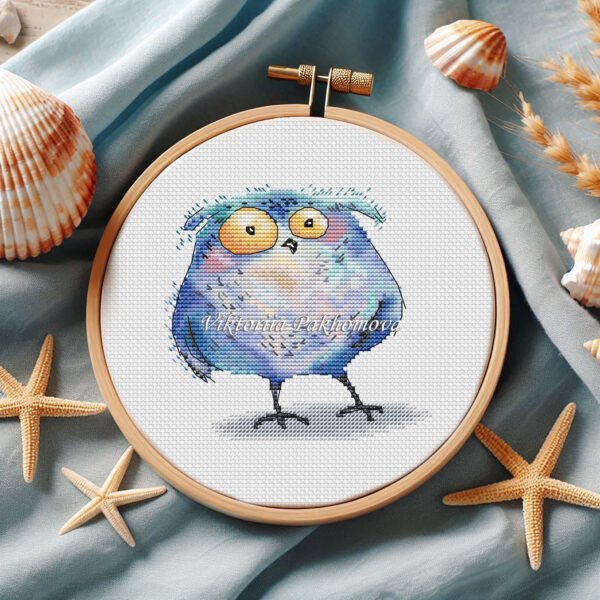 Whimsical Tawny Owl cross stitch pattern displayed in a wooden embroidery hoop with pastel bird details