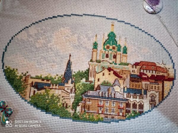 Kyiv Andriyivskyi Descent cross stitch displayed with cozy decor, colorful summer city embroidery