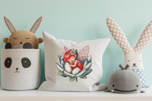 Fairy cross stitch design displayed on decorative pillow for nursery décor and kids room