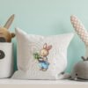 Spring bunny boy cross stitch design displayed on decorative pillow for nursery décor