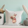 Spring bunny girl cross stitch design displayed on decorative pillow for nursery décor