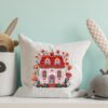 Finished embroidery a floral folk art spring house with Scandinavian motifs and blooming flowers on a pillow case
