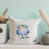 cross stitch artwork of a whimsical tawny owl on decorative pillow case
