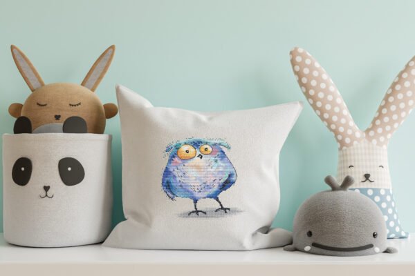 cross stitch artwork of a whimsical tawny owl on decorative pillow case