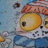 3slqP2aX9z0 finished cross stitch artwork featuring a whimsical chamomile cat with bees and floral details in soft bright colors