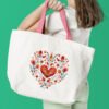 Floral heart cross stitch design displayed on tote bag