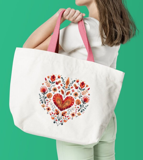 Floral heart cross stitch design displayed on tote bag