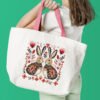 Romantic bunny cross stitch design displayed on tote bag