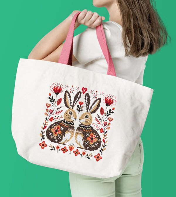 Romantic bunny cross stitch design displayed on tote bag