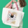 Finished cross stitch artwork of a humorous black cat in a Da Vinci‑style pose with bold lines and soft background tones on tote bag