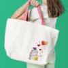 finished cross stitch artwork featuring a cute romantic cat with colorful hearts on tote bag