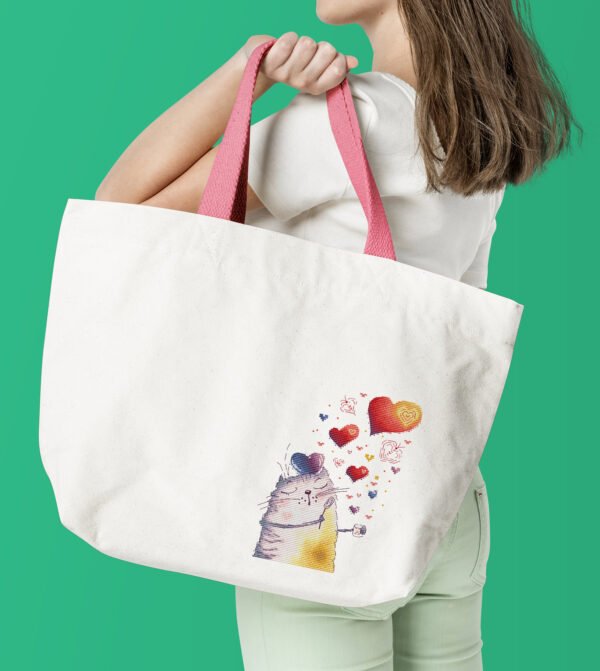 finished cross stitch artwork featuring a cute romantic cat with colorful hearts on tote bag