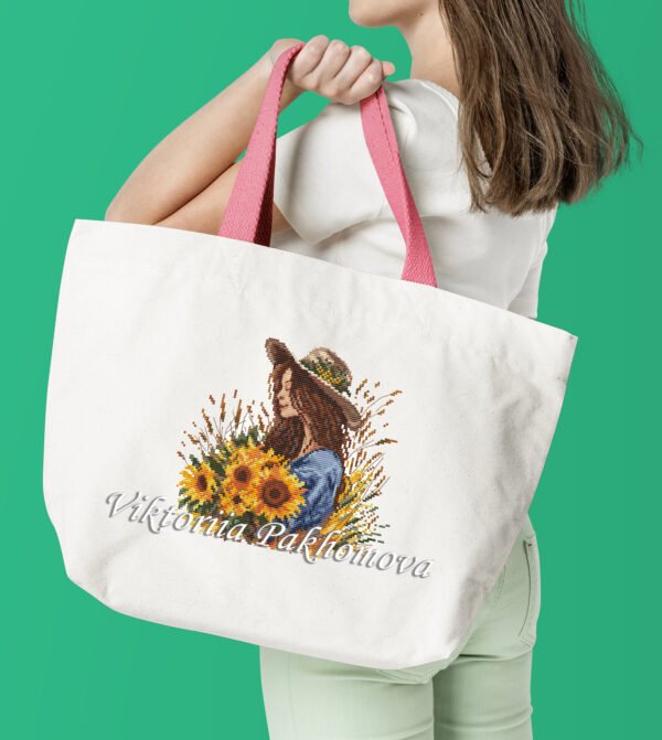 Girl with sunflower cross stitch design stitched on tote dag