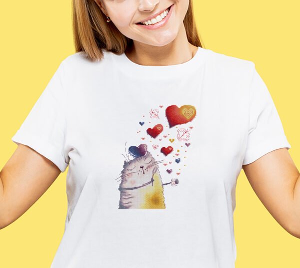 finished cross stitch artwork featuring a cute romantic cat with colorful hearts on t-shirt