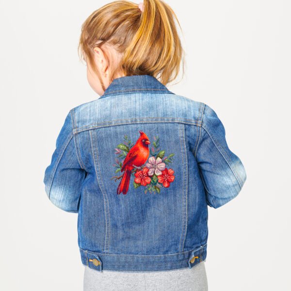 Girl's blue denim jacket in studio Floral cardinal cross stitch design stitched on denim jacket
