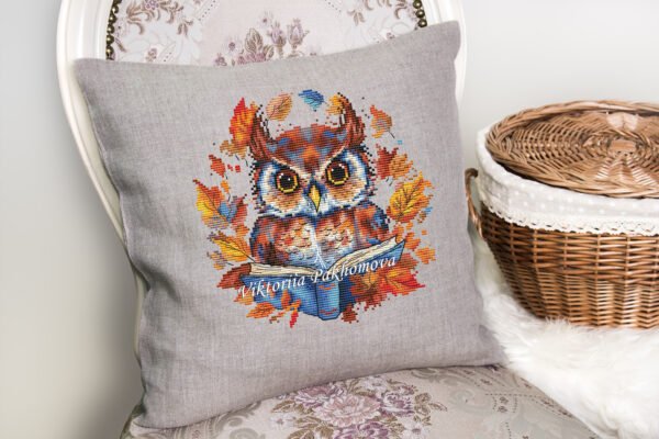 Autumn owl cross stitch design displayed on decorative pillow