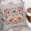 56 Romantic swans cross stitch design displayed on decorative pillow