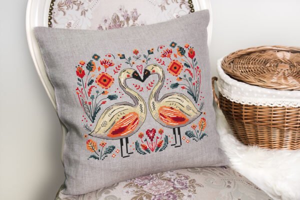 56 Romantic swans cross stitch design displayed on decorative pillow