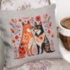 Romantic dogs cross stitch design displayed on decorative pillow