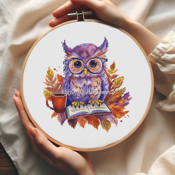 57 Autumn Owl cross stitch pattern displayed in a wooden embroidery hoop with warm fall colors