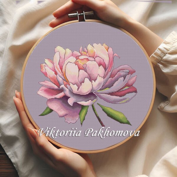 Peony flower cross stitch pattern in embroidery hoop with purple and pink petals