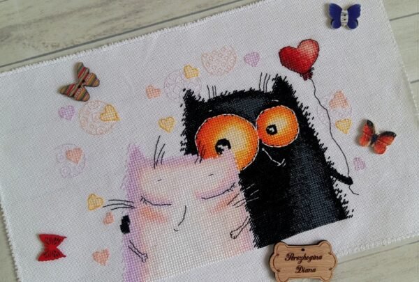 finished cross stitch artwork featuring two cats in love with bright hearts and soft expressive shading