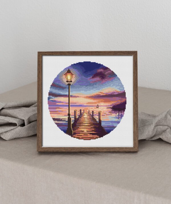 65 Framed sunrise marine landscape cross stitch with wooden pier and vibrant sky colors, peaceful coastal embroidery artwork by Viktoriia Pakhomova