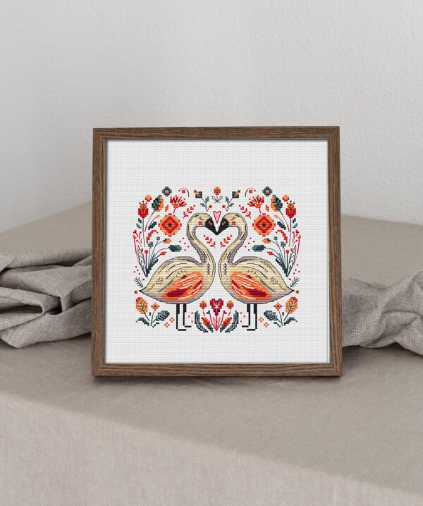 65 Framed cross stitch artwork of two romantic swans forming a heart, surrounded by colorful Scandinavian folk art flowers