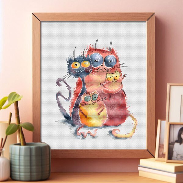68 Framed cross stitch artwork featuring four bright, playful cats in bold colors with whimsical expressions.