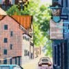 Close‑up of Neuruppin city cross stitch with buildings, flowers, and blue car