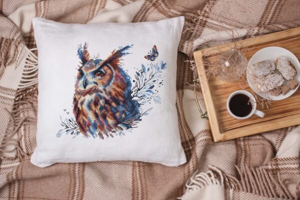 Decorative pillow with mystical owl cross stitch design, cozy autumn home decor embroidery