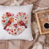 White linen pillow, cushion Mockup on plaid. Inrerior photo Birds heart cross stitch design displayed on decorative pillow